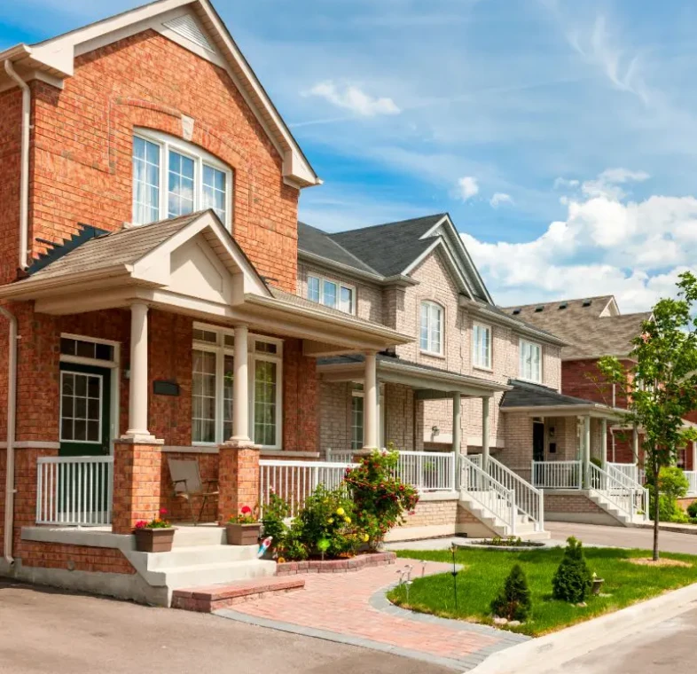 Row of modern suburban brick houses with front porches.